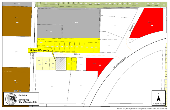 Zoning Map: The zoning map depicts the subject parcel, depicted by black hatching and a black outline, located at 1313 W 30th Street, immediately south of W 30th Street. Parcels within Bay County are depicted in the color white. The parcel is currently located within western Bay County. Parcels located within the City of Panama City zoned Residential-1, R-1 depicted by are located to the west depicted by a light-yellow color and parcels zoned Residential-2, R-2 are located to the east depicted by the color yellow. Parcels zoned R-2 are located to the north across W 30th Street. Parcels zoned Light Industrial, depicted by the color grey are located further north and located within the City of Panama City. Parcels located immediately to the south are located within Bay County. Parcels to the east across Lisenby Avenue are located within the City of Panama City and zoned Mixed Use-3, MU-3, depicted by the color brown. Parcels located within the City of Panama City are also located to the east and northeast and zoned General Commercial-2, GC-2 depicted by the color red.